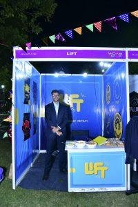 A student displays his business at the MIDAS Bazaar.
